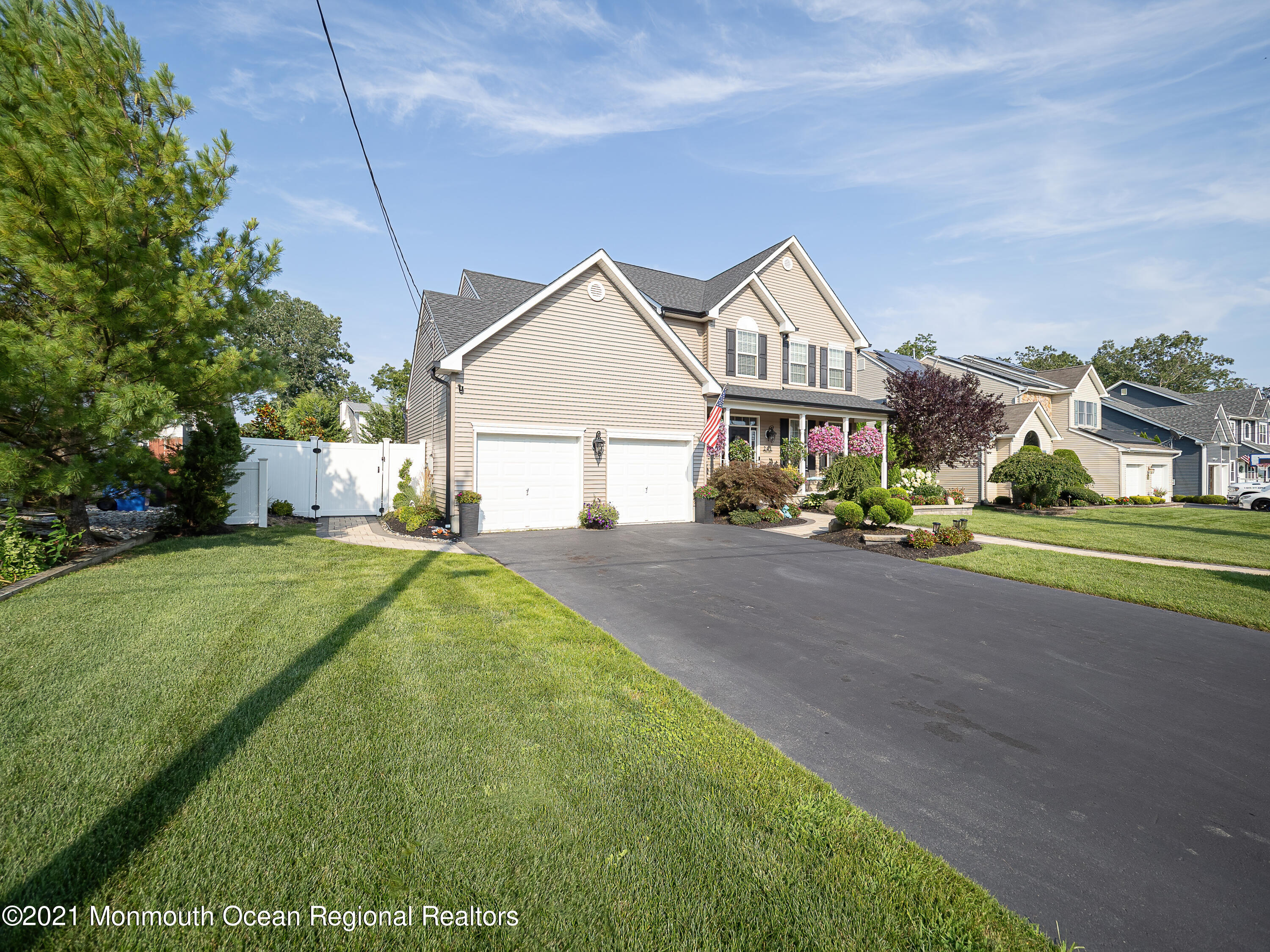 241 Privateer Road Manahawkin, NJ 08050 - Photo 23 of 44 a house with huge green field in front of it