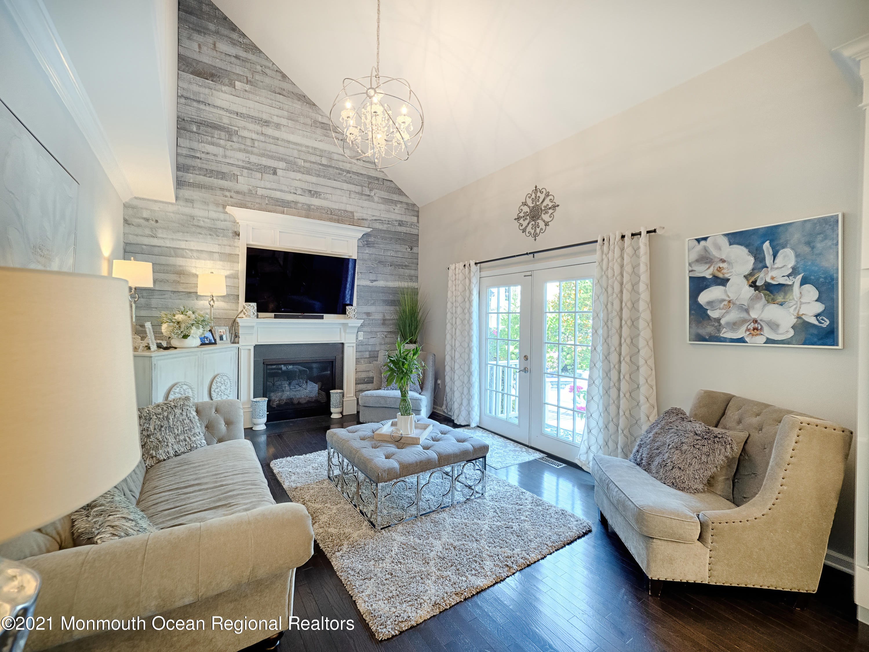 241 Privateer Road Manahawkin, NJ 08050 - Photo 31 of 44 a living room with furniture a fireplace and a flat screen tv