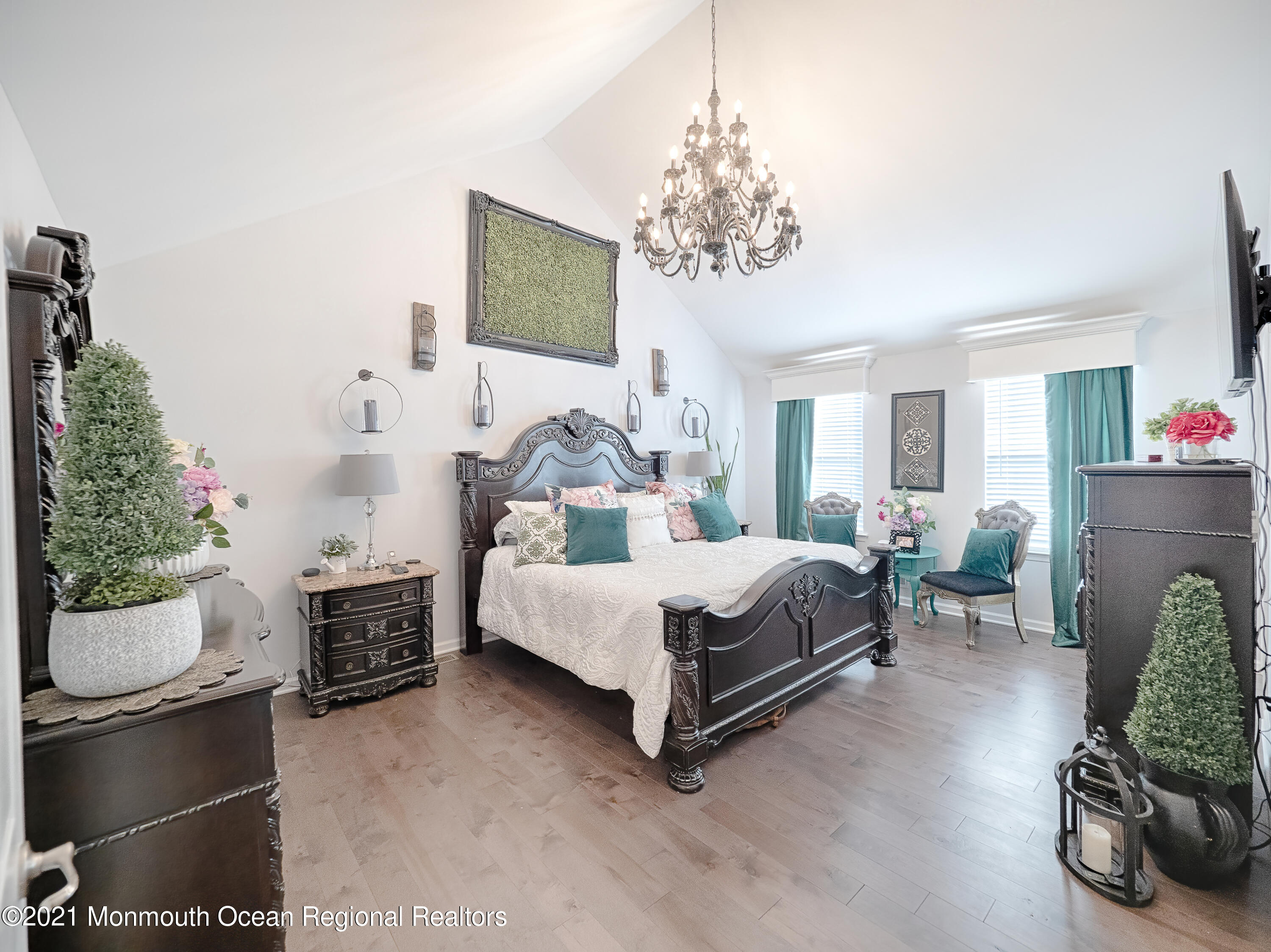 241 Privateer Road Manahawkin, NJ 08050 - Photo 34 of 44 a bedroom with a bed couch and a chandelier
