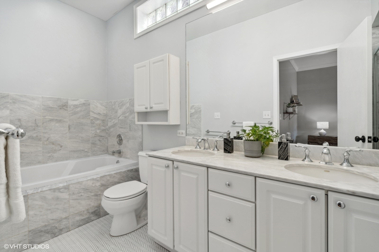 829 West Wolfram Street, Unit 2 Chicago, IL 60657 - Photo 12 of 17 a bathroom with a granite countertop sink a toilet and bathtub