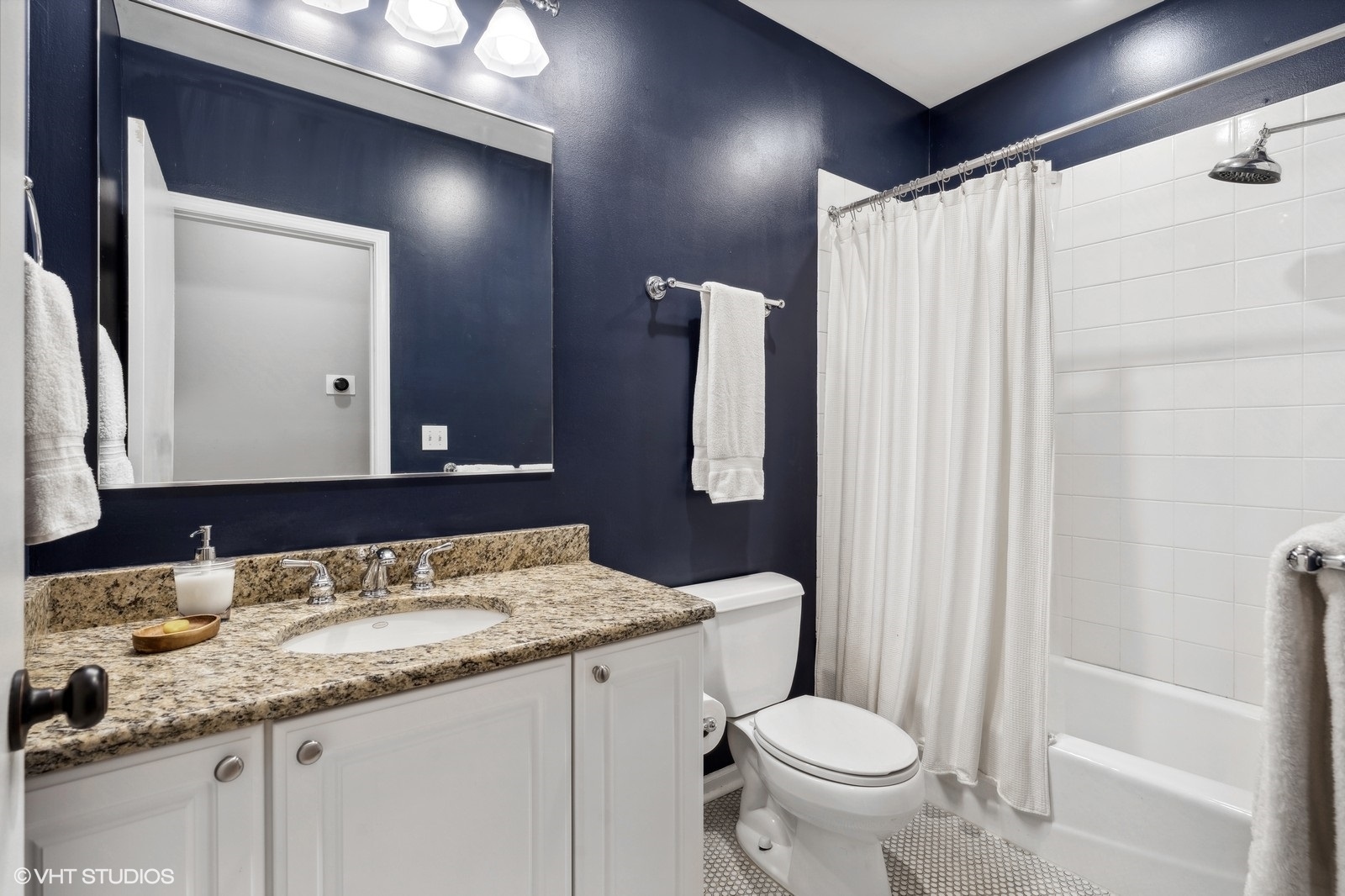 829 West Wolfram Street, Unit 2 Chicago, IL 60657 - Photo 15 of 17 a bathroom with a granite countertop toilet sink and mirror