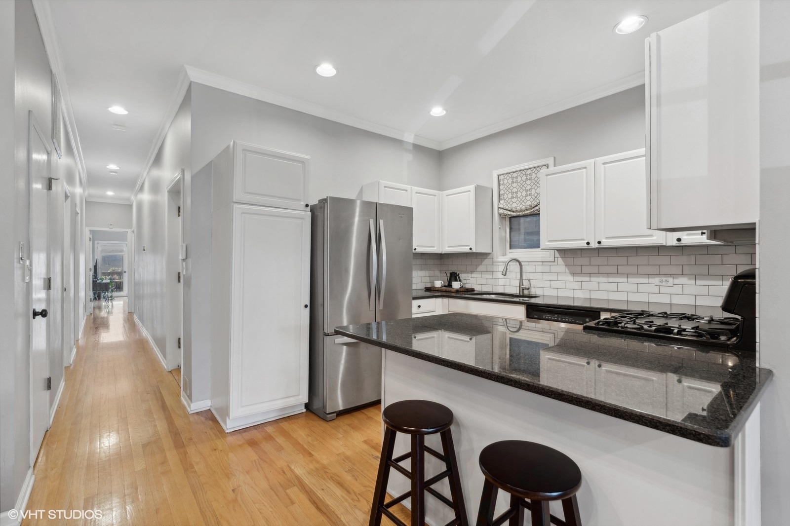 829 West Wolfram Street, Unit 2 Chicago, IL 60657 - Photo 7 of 17 a kitchen with a refrigerator and a stove top oven