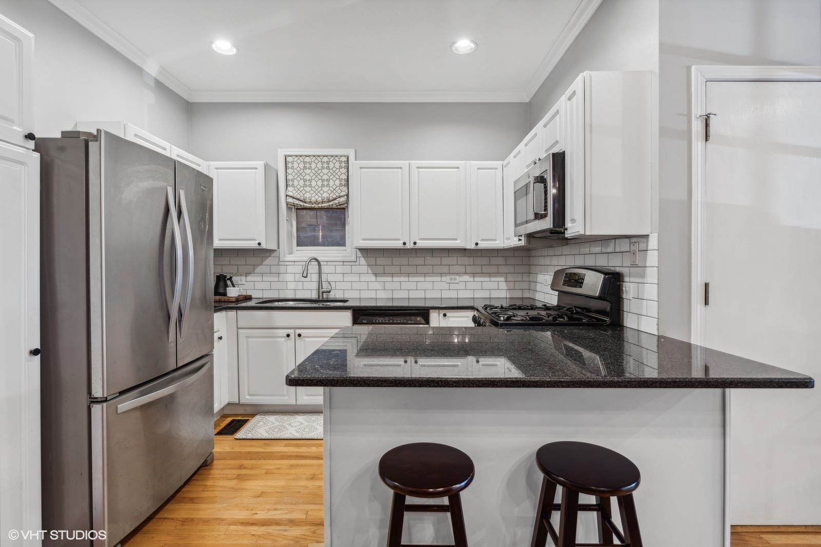 829 West Wolfram Street, Unit 2 Chicago, IL 60657 - Photo 8 of 17 a kitchen with stainless steel appliances granite countertop a refrigerator a sink dishwasher a stove and white cabinets