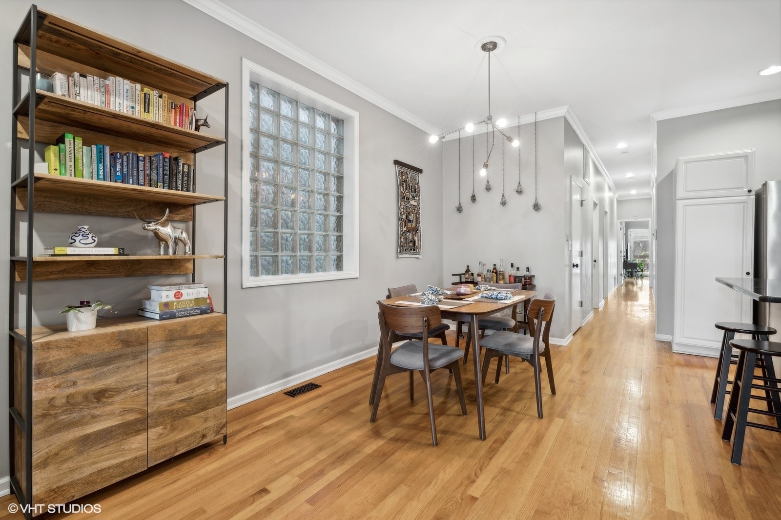 829 West Wolfram Street, Unit 2 Chicago, IL 60657 - Photo 10 of 17 a dining room with wooden floor a chandelier a wooden table and chairs