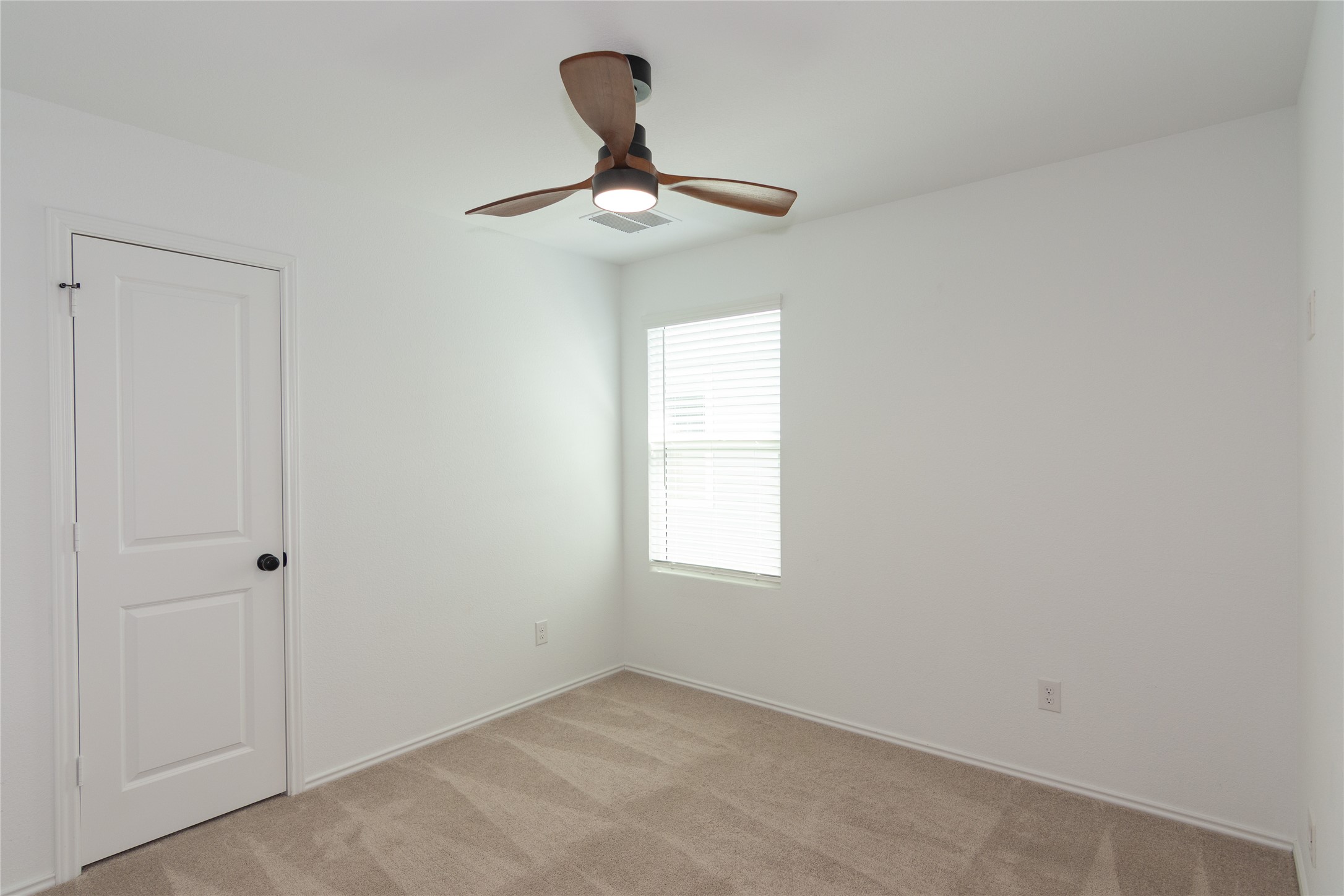 548 Rancho Del Cielo Loop Jarrell, TX 76537 - Photo 20 of 40 Neutral tone wall paint with wood-finish ceiling fan and integrated lighting