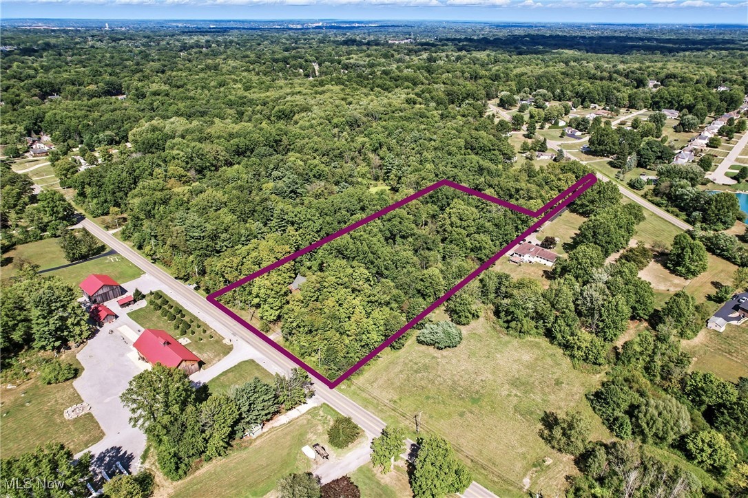 4957 South Raccoon Road Canfield, OH 44406 - Photo 11 of 43 Aerial view of property and surrounding area with property boundaries highlighted and a heavily wooded area