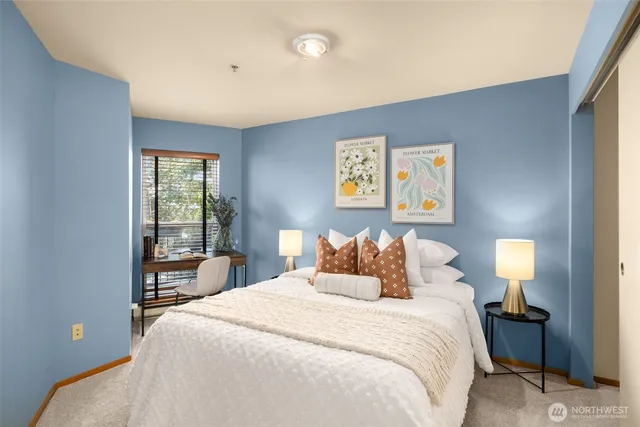 a bedroom with a bed and a large window