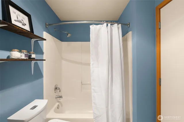 a bathroom with a shower and a tub