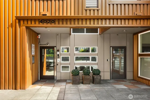 a view of front door with potted plants