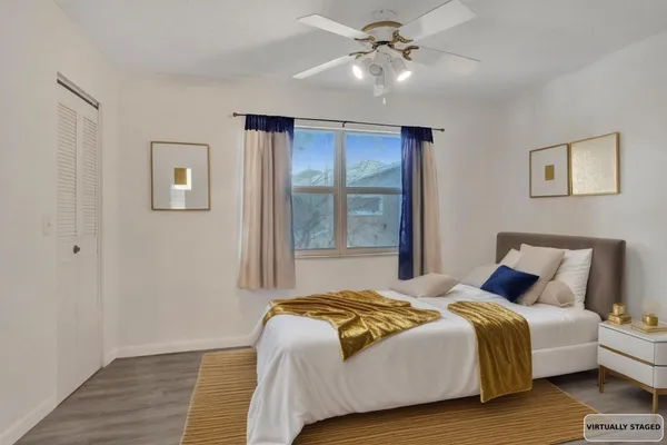 a bedroom with a large bed and a window