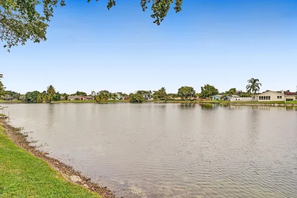 a view of a lake with houses in the back