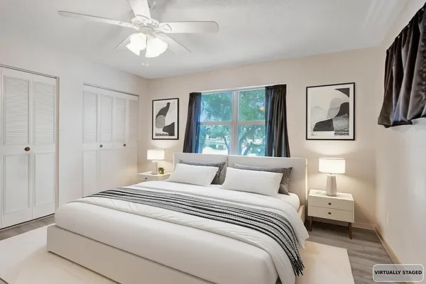 a bedroom with a large bed and a chandelier