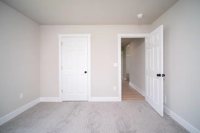 a view of an empty room and closet area