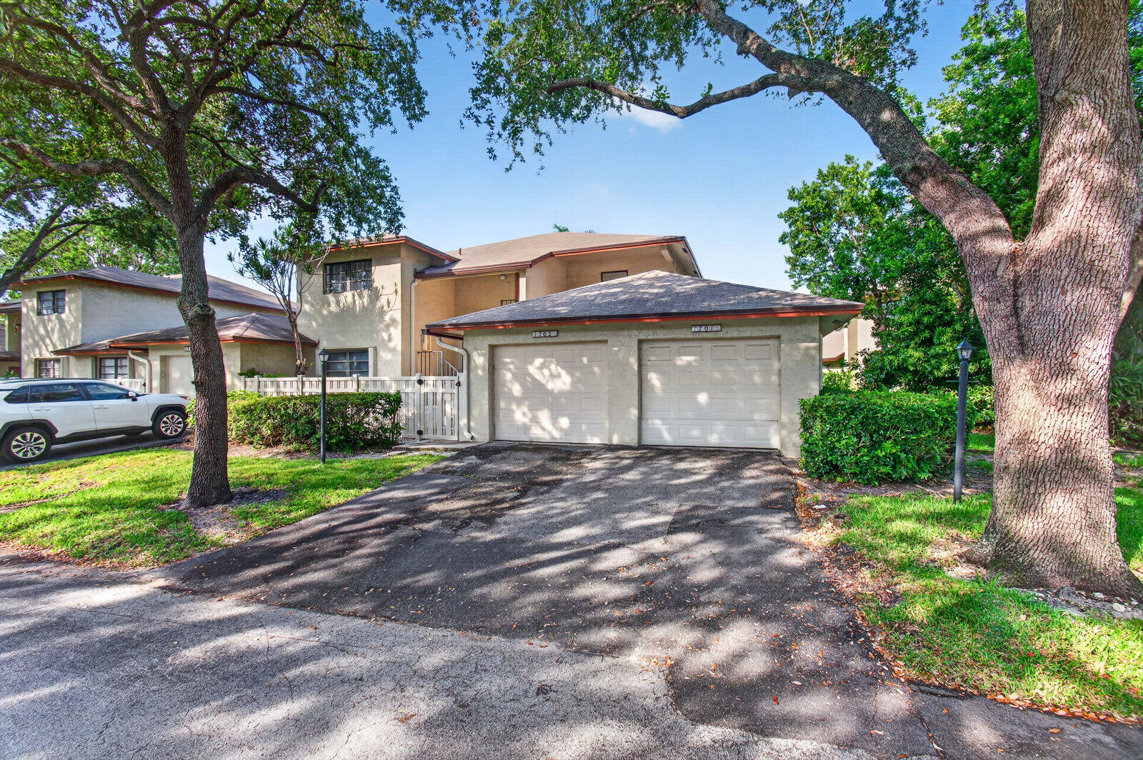 3951 Northeast 19th Road, Unit 1701 Pompano Beach, FL 33064 - Photo 64 of 82 a front view of a house with a garden and trees