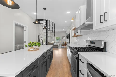 a kitchen with stove and refrigerator