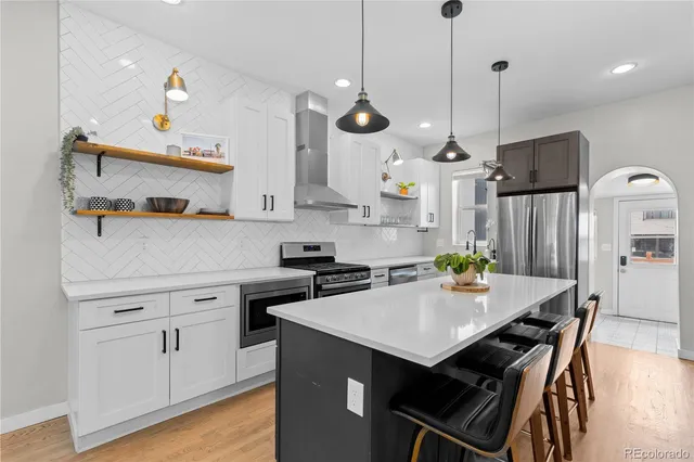 a kitchen with a dining table chairs sink and stove