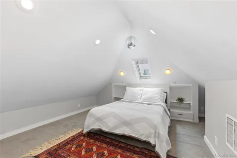 a bedroom with a bed and a night stand