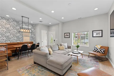 a living room with furniture and a dining table