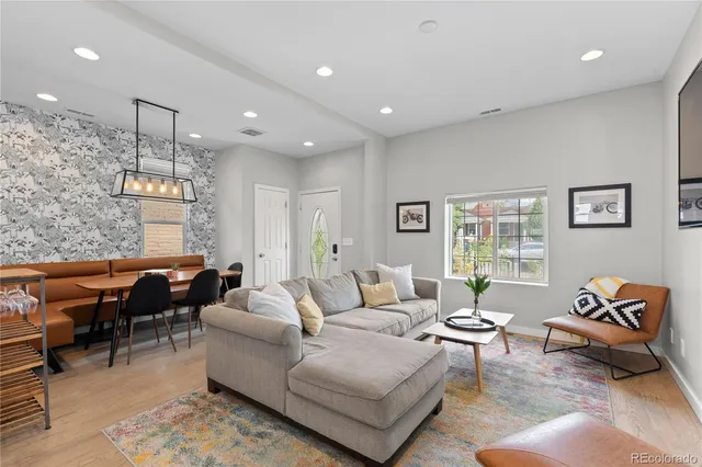 a living room with furniture and a dining table