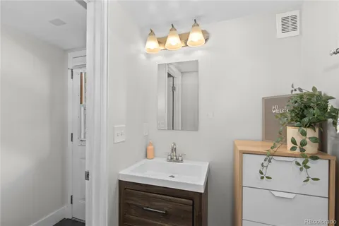 a bathroom with a sink a vanity and a mirror
