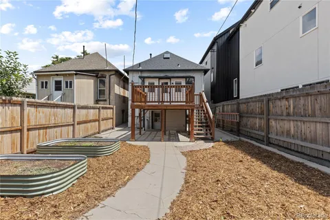 a front view of a house with wooden fence