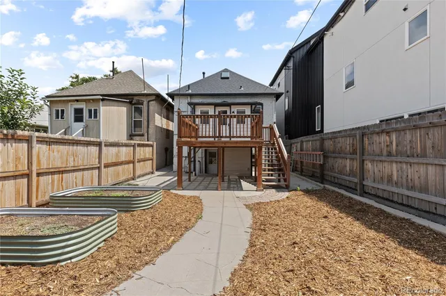 a front view of a house with wooden fence