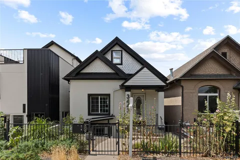 a front view of house along with deck and outdoor seating