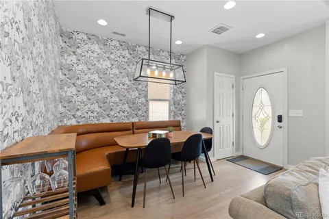 a living room with furniture a window and a chandelier