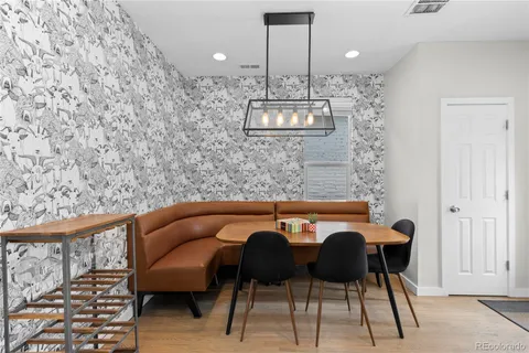 a view of a dining room with furniture and wooden floor