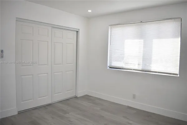 an empty room with closet area