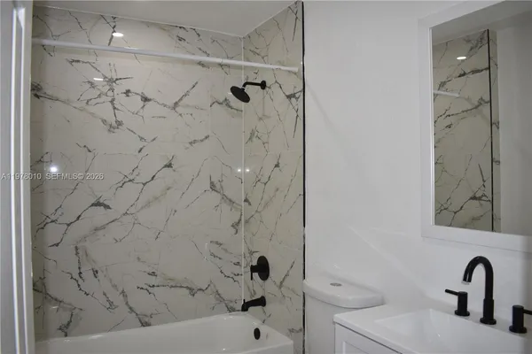 a bathroom with a sink and mirror