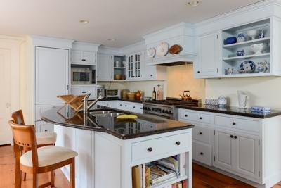 270 Stage Harbor Road Chatham, MA 02633 - Photo 11 of 25 a kitchen with stainless steel appliances granite countertop a stove a sink dishwasher and white cabinets with wooden floor