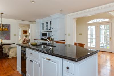 270 Stage Harbor Road Chatham, MA 02633 - Photo 14 of 25 a kitchen with granite countertop a sink and white cabinets