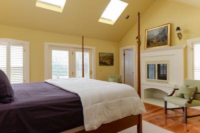 270 Stage Harbor Road Chatham, MA 02633 - Photo 17 of 25 a bedroom with a bed a table and chair