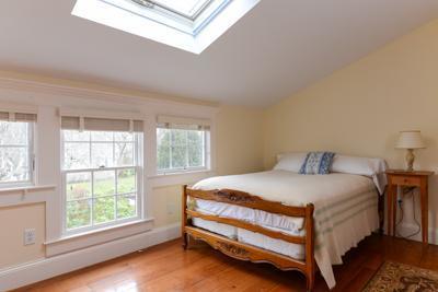 270 Stage Harbor Road Chatham, MA 02633 - Photo 22 of 25 a bed sitting in a bedroom next to a window