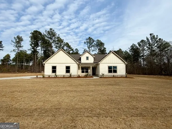 a house with trees in the background