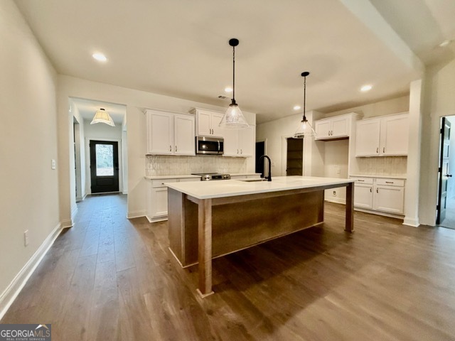 133 Kimbell Road Pine Mountain, GA 31822 - Photo 3 of 17 a kitchen with kitchen island granite countertop a sink cabinets and wooden floor
