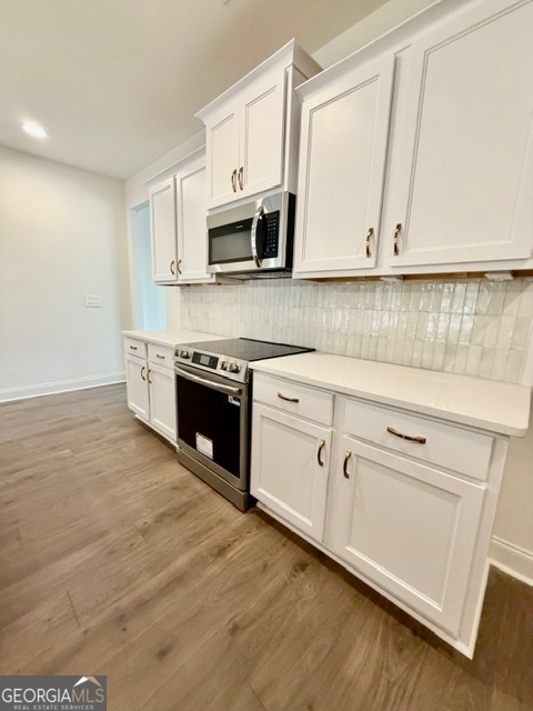 133 Kimbell Road Pine Mountain, GA 31822 - Photo 7 of 17 a kitchen with stainless steel appliances white cabinets and a wooden floor