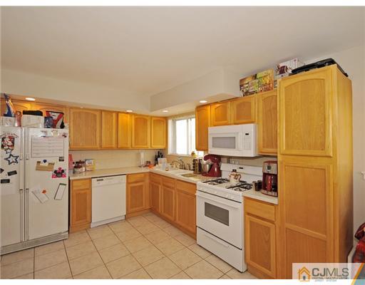 45 Rock Hill Road Old Bridge, NJ 08857 - Photo 3 of 14 a kitchen with a white cabinets and white appliances