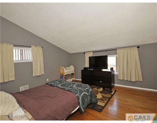 45 Rock Hill Road Old Bridge, NJ 08857 - Photo 7 of 14 a bedroom with a bed and wooden floor