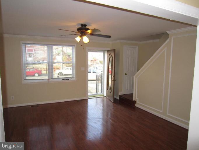 1725 Pin Oak Road Parkville, MD 21234 - Photo 3 of 18 a view of an empty room with wooden floor and a window