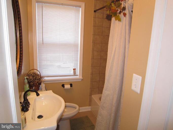 1725 Pin Oak Road Parkville, MD 21234 - Photo 7 of 18 a bathroom with a sink and a mirror