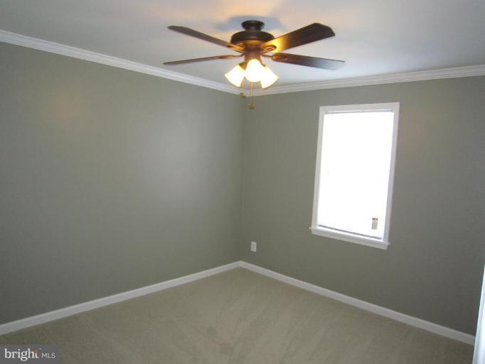 1725 Pin Oak Road Parkville, MD 21234 - Photo 8 of 18 an empty room with a window and a fan