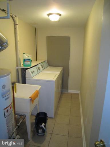 1725 Pin Oak Road Parkville, MD 21234 - Photo 9 of 18 a bathroom with a sink a toilet and a mirror