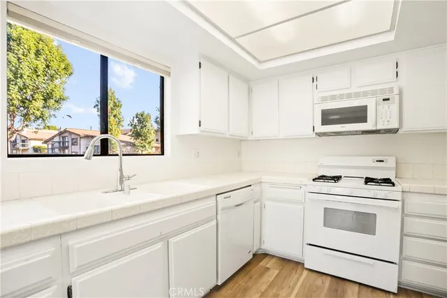 a kitchen with appliances cabinets and a sink