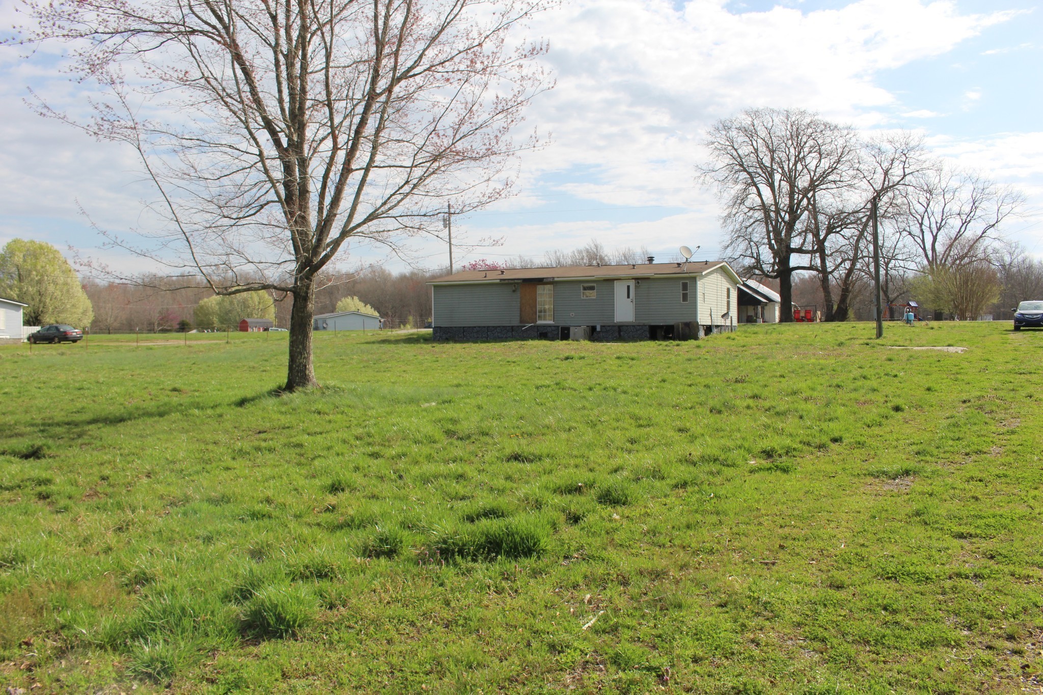 1117 Bob Meadows Road Manchester, TN 37355 - Photo 2 of 4 a view of a backyard with large trees