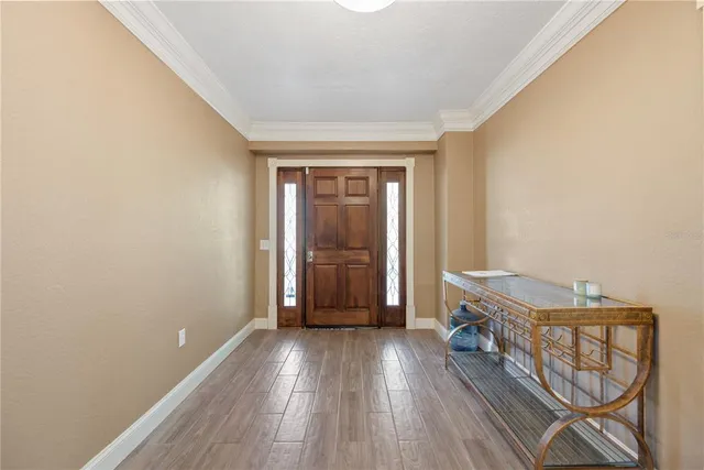 a view of an empty room with window and cabinet