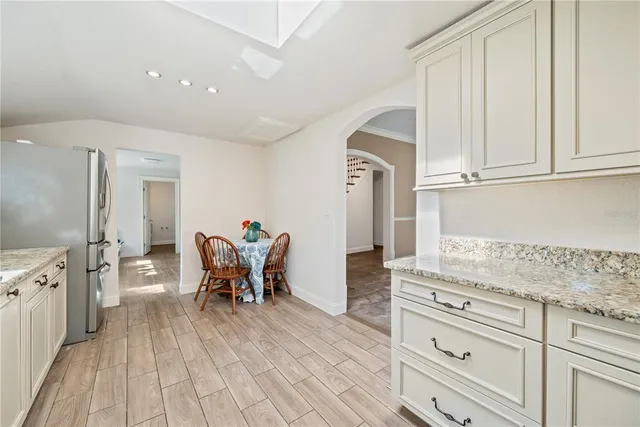 a kitchen with granite countertop a stove sink and cabinets