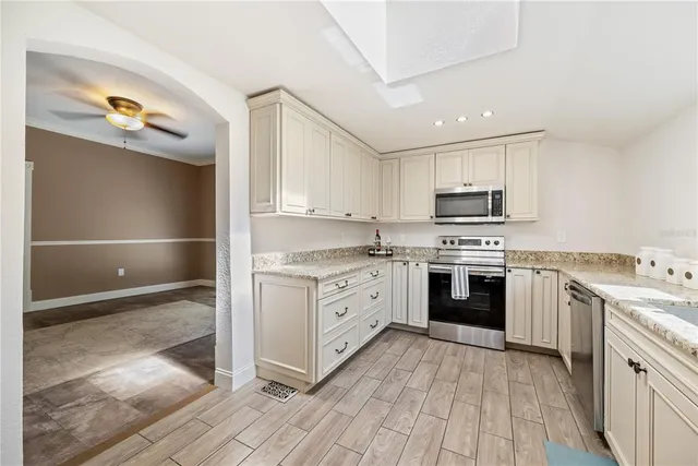 a bathroom with a granite countertop toilet sink and mirror
