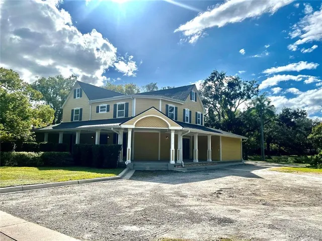 a front view of a house with a yard and swimming pool